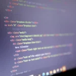 Illuminated HTML code displayed on a computer screen, close-up view.