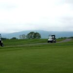 A serene golf course in Crozet, VA featuring golf carts and lush greenery.