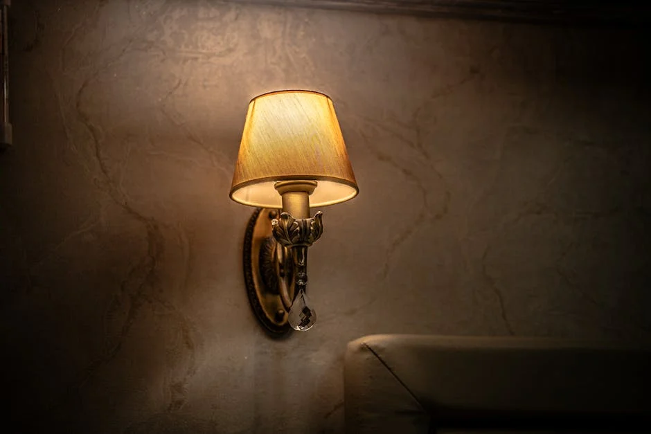 Vintage wall sconce casting a warm and cozy glow in an indoor setting, perfect for ambiance.