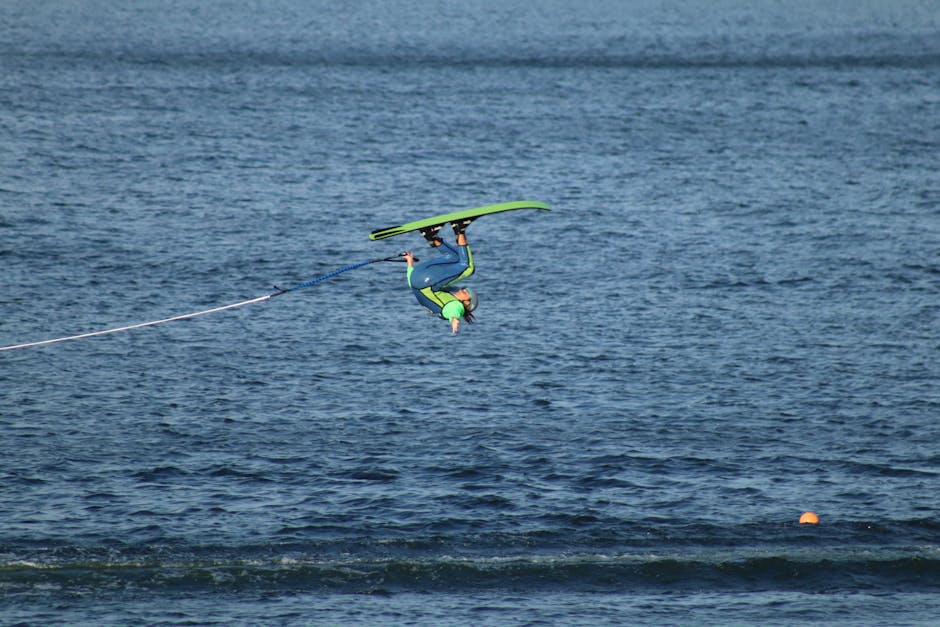 A thrilling moment of a person performing an aerial waterski trick on a sunny day.