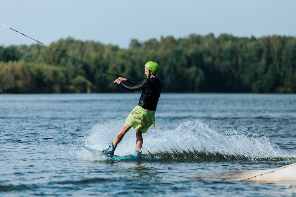 An adult male enjoying a thrilling wakeboarding session on a serene lake.