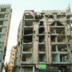 Rubble and decay of a war-damaged building in Homs, Syria, highlighting urban devastation.