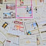 A vibrant array of newspapers laid out in Fès, showcasing diverse stories.
